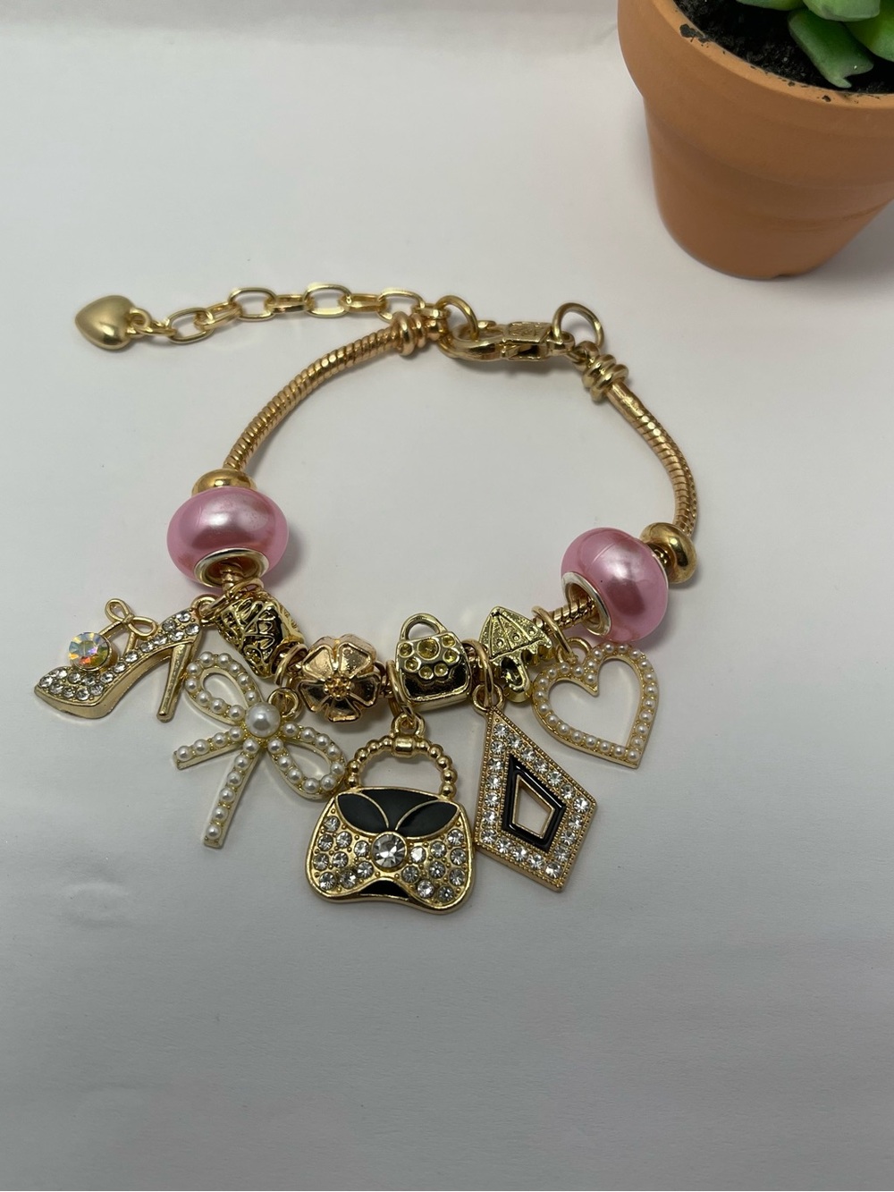 Gold-Tone Pink Bead Charm Bracelet with Fashion Charms
